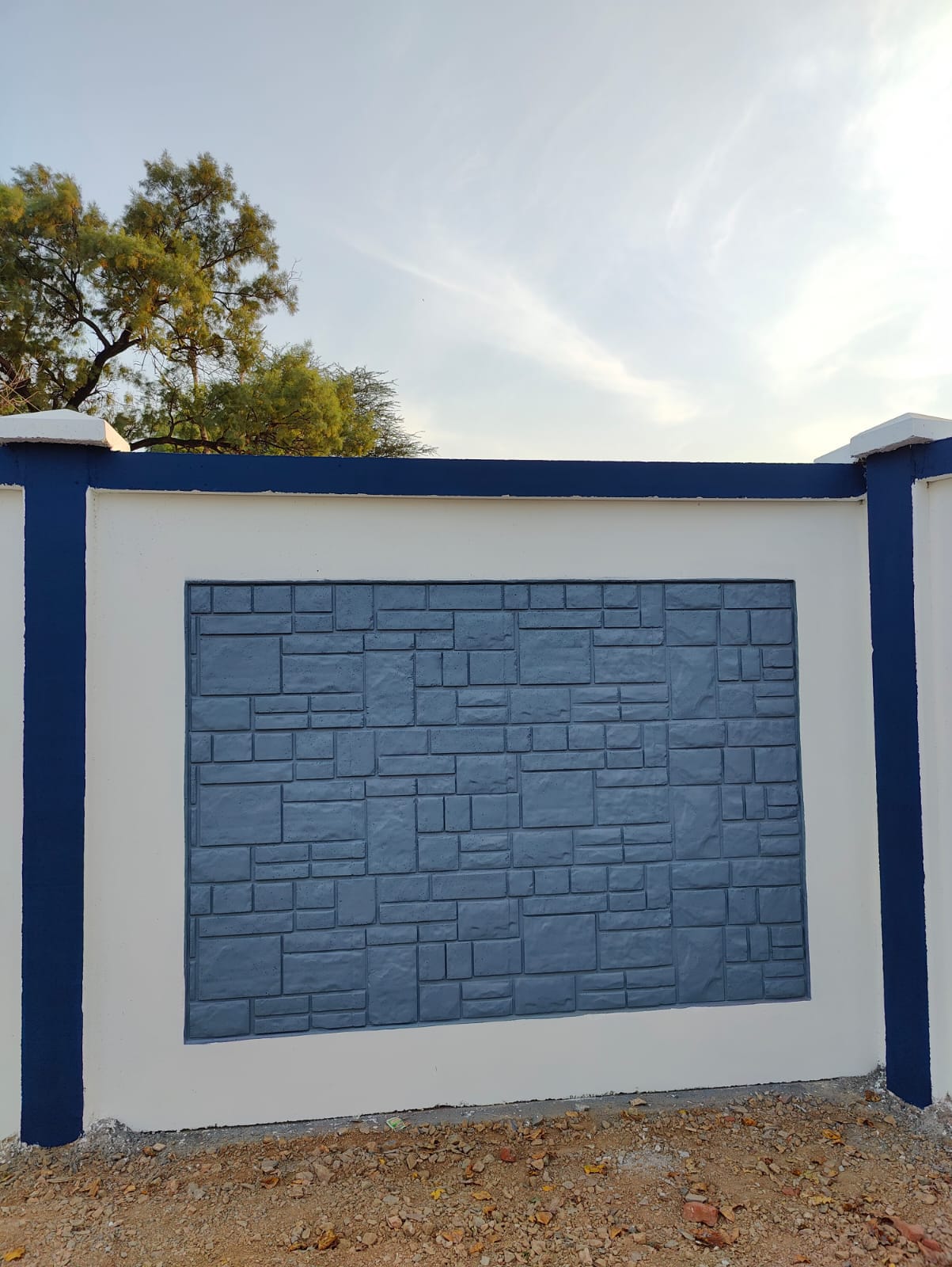 Row of compound wall panels finished in grey, cyan, yellow, navy and orange