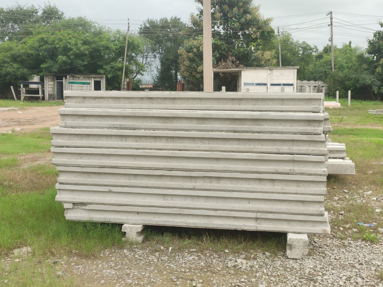 Stack of ribbed-profile precast wall panels at the yard